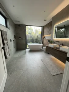 Large-format tiles creating a seamless modern bathroom look
