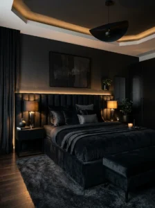 Full black bedroom with warm lighting and luxury decor.