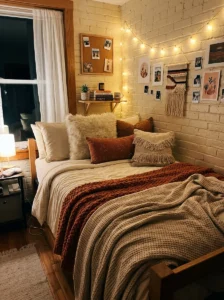 Cozy dorm bed with layered bedding and soft warm textures.