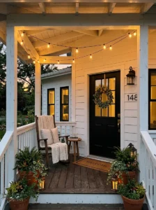 Small front porch illuminated with warm string lights.