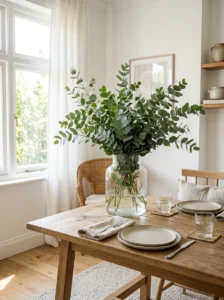 Dining table centerpiece with fresh greenery.