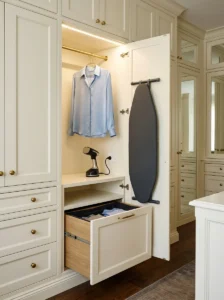 Dressing room garment-care nook with steamer, fold-down ironing board and concealed hamper.