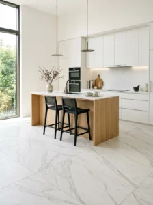 Modern kitchen with large marble-look porcelain floor tiles.