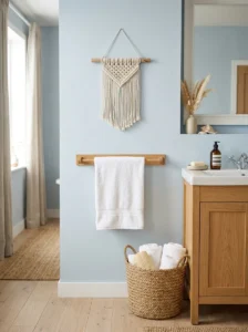 Small cream macrame wall hanging adding natural texture to a coastal bathroom wall.