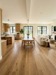 : Open concept home with continuous warm oak flooring connecting kitchen, dining, and living areas.