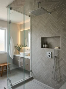 Gray herringbone tile adding texture to a shower.