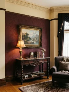 Victorian living room with subtle burgundy damask wallpaper and carved wood furniture.