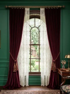Victorian living room with burgundy velvet curtains layered over ivory sheers.