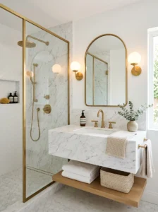 White bathroom with elegant brass fixtures.