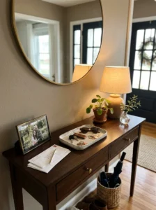Decorative tray organizing keys and mail on an entryway console