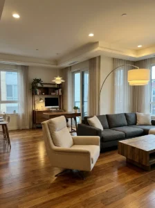 Modern swivel accent chair positioned between a living room and home office.