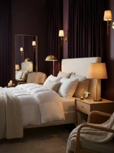 Deep plum bedroom walls with cream bedding and brass accents