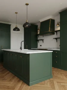 Dark green kitchen combining brass hardware with subtle black metal accents.