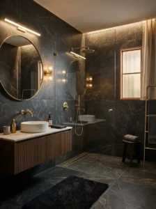 Dark bathroom tile with subtle metallic veining and warm brass fixtures
