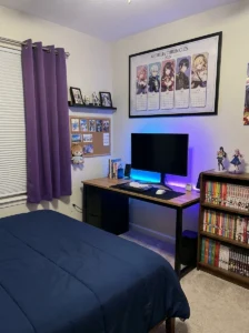 Anime artwork calendar displayed above a coordinated bedroom desk.